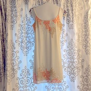 White mini dress with pink, orange, and white sequins.